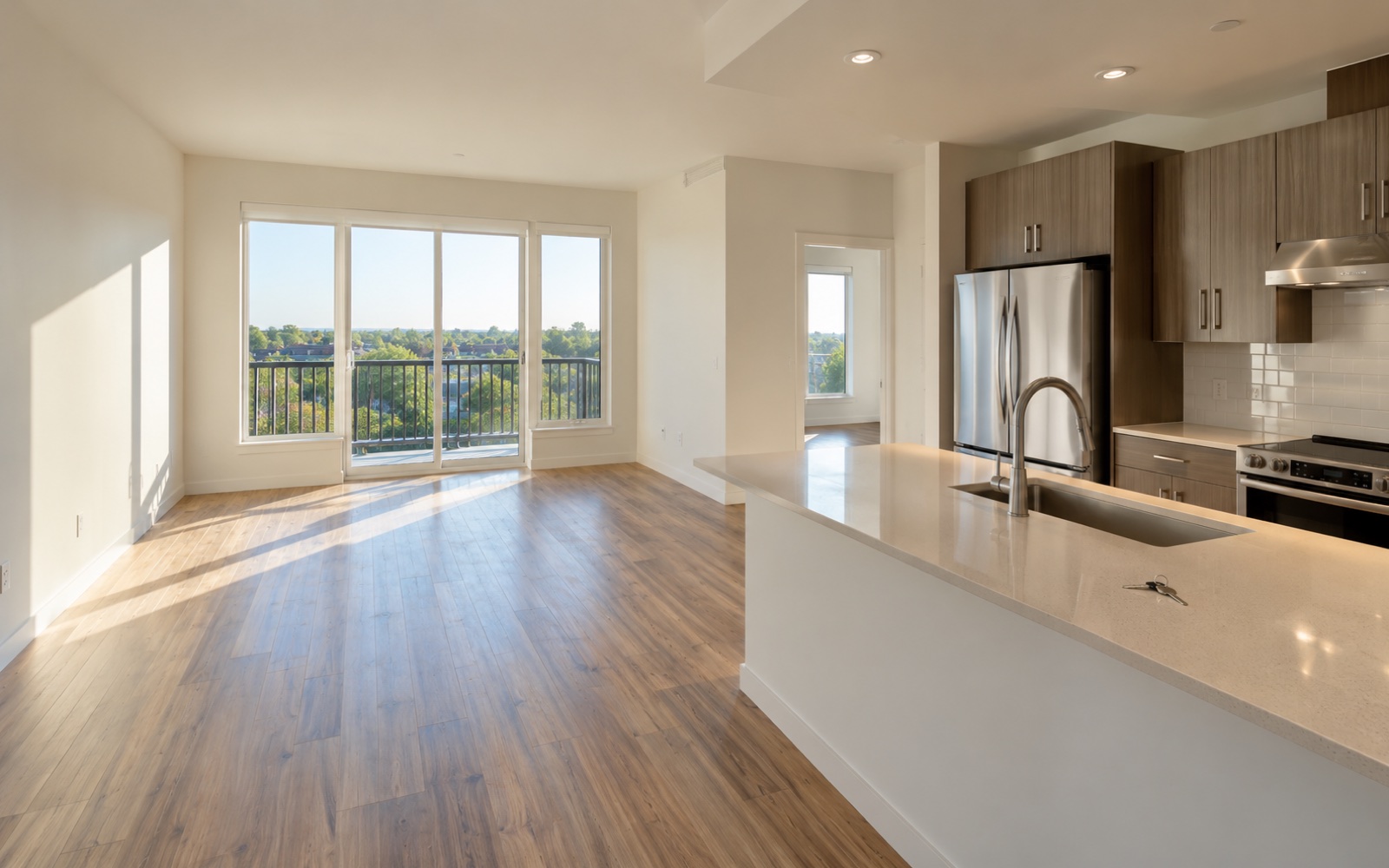Vacant bright living room and kitchen with key on counter